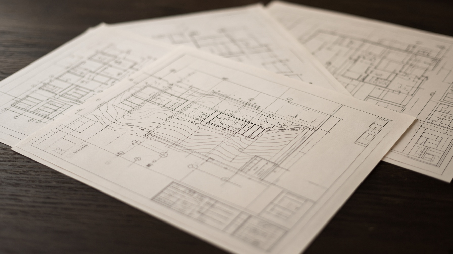 Blurred site drawings and construction plans on a work table