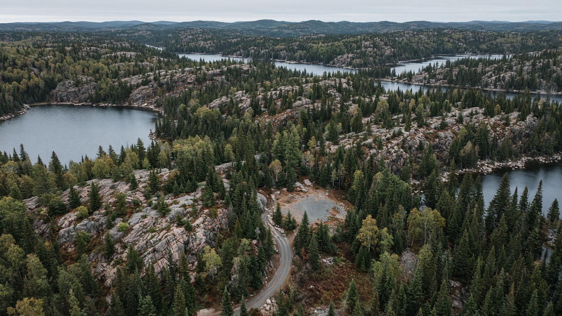 Aerial view of Northern Ontario cottage country lakes, forest, and a cleared lot